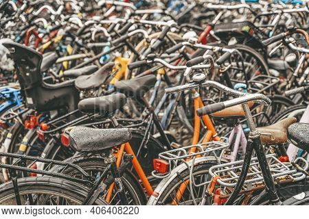 Bicycle Parking With Lot Of Bicycles, Rainy Day, Urban Iconic Transport In Amsterdam.