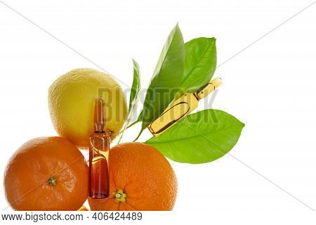 Vitamin C Injection.a Solution Of Vitamin C In Brown Ampoules Set And Citrus Fruit Isolated On White