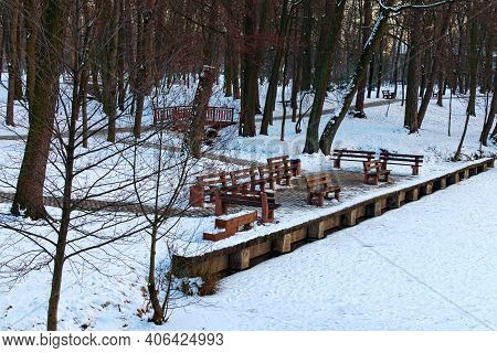 Resting Area With Wooden Empty Benches At The Lake Shore. Scenic Winter Landscape In The Pushcha-vod