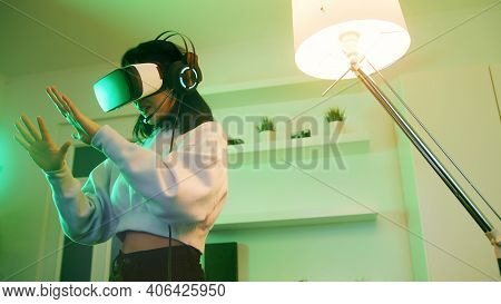 Young Woman With Vr Headset Experiencing Virtual World For First Time. High Quality Photo