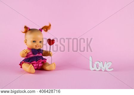 Freckled White Doll Girl With Two Curly Red Tails Holds A Heart  On A Pink Background With The Inscr