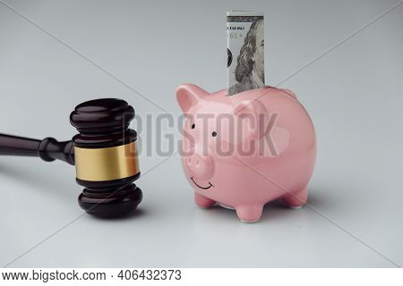 Judge Wooden Gavel And Piggy Bank With Dollar Bill. Loan And Finance Concept