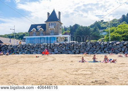 Plerin, Brittany, France - 24 August 2019: People Sunbathing On Sandy Atlantic Beach La Plage Des Ro