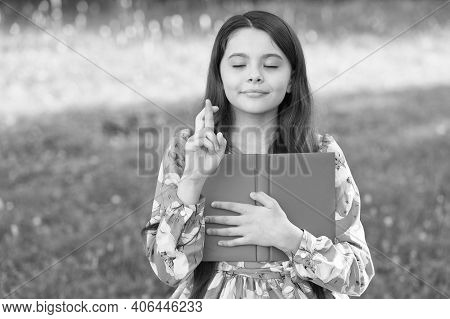 Making A Wish. Little Child Cross Fingers For Luck. Small Girl Hold Book In Park. Follow Your Dream.