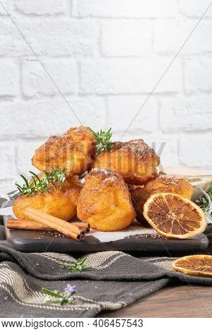 Traditional Portuguese Christmas Sweets Sonhos With Sugar And Cinnamon On Kitchen Countertop.