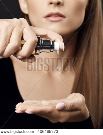 Closeup Of Young Pretty Woman Pouring Drop Hair Styling Cosmetics To Hand For Making Hairstyle Of Si
