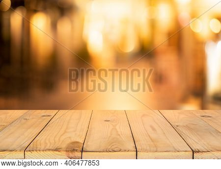 Wood Table Top (bar) With Blur Light Bokeh In Dark Night Cafe,restaurant Background.no People