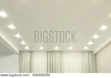 White Stretch Ceiling With Spot Lights In Room