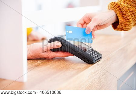 Customer Using Credit Card For Payment To Owner At Shop, Cashless Technology And Credit Card Payment