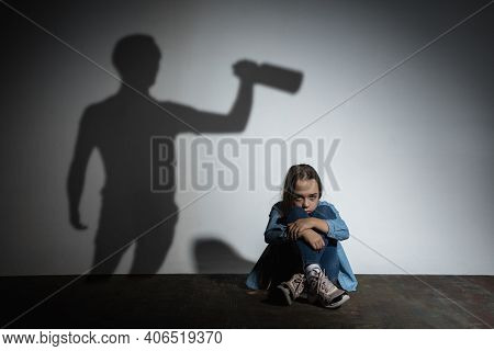 Domestic Physical Violence, Abusing. Scared Little Caucasian Girl, Victim Sitting Close To White Wal