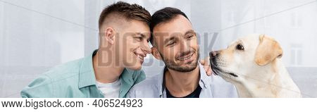 Happy Same Sex Couple Smiling And Looking At Labrador, Banner.