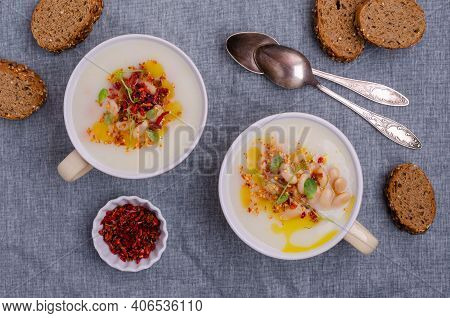 Vegetable Cream Soup With Beans And Spicy Oil In A Bowl On A Textile Background. Selective Focus.