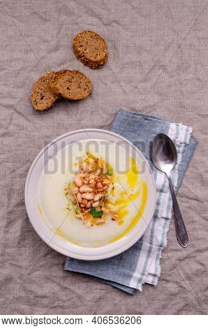 Vegetable Cream Soup With Beans And Spicy Oil In A Bowl On A Textile Background. Selective Focus.