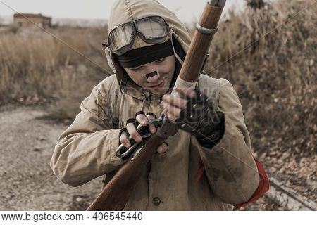 Wandering Boy. Boy With A Gun. Boy Goes To An Abandoned Building. Boy Stands In Front Of A Building.