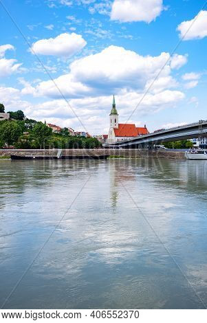 Bratislava, Slovakia, The St. Martin Cathedral Seen From The Danube River Bank With The Snp Bridge O