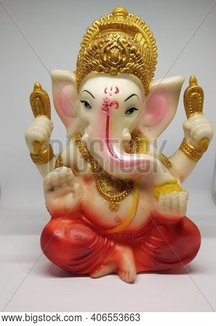 Statue Of Hindu Idol Ganesha Selectively Focused With White Background.