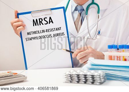 Doctor Holds Paper With Inscription Mrsa Methicillin-resistant Staphylococcus Aureus, Stethoscope An
