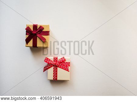 Two Small Gift Boxes With Tied Decorative Bow And Red Ribbon On White Background.holidays Present Co