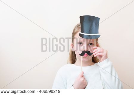 Purim, Fools Day, Halloween, Birthday Concept. Little Child Girl Age 7-8 With Funny Paper Carnival M