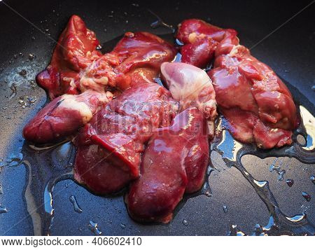 Chicken Liver, Kidney And Heart In A Non-stick Skillet. The Offal Of The Bird Is Placed In A Dark Bo