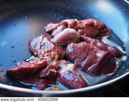 Chicken Liver, Kidney And Heart In A Non-stick Skillet. The Offal Of The Bird Is Placed In A Dark Bo