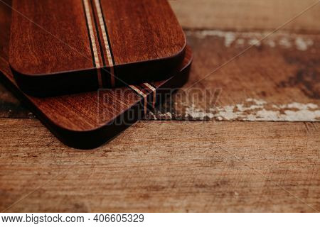 Set Of Wooden Cuttng Boads On Wooden Background. Wooden Kitchen Block Close Up.