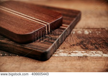 Set Of Wooden Cuttng Boads On Wooden Background. Wooden Kitchen Block Close Up.