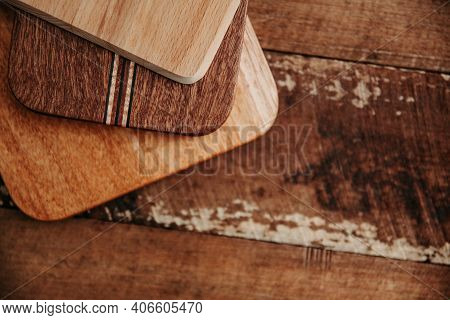 Set Of Wooden Cuttng Boads On Wooden Background. Wooden Kitchen Block Close Up.