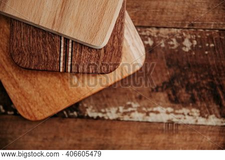 Set Of Wooden Cuttng Boads On Wooden Background. Wooden Kitchen Block Close Up.