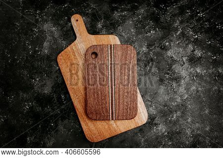 Set Of Wooden Cuttng Boads On Black Background. Wooden Kitchen Block Close Up.