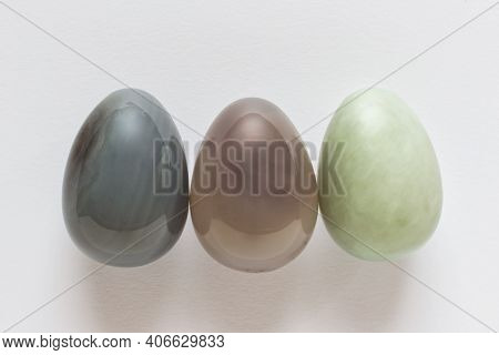 Three Decorative Precious Stone Easter Eggs On White Background.