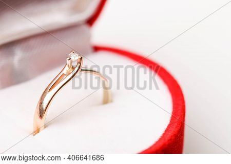 Engagement Ring From The Combined Gold With Diamond In Red Velvet Gift Box Isolated On White Backgro