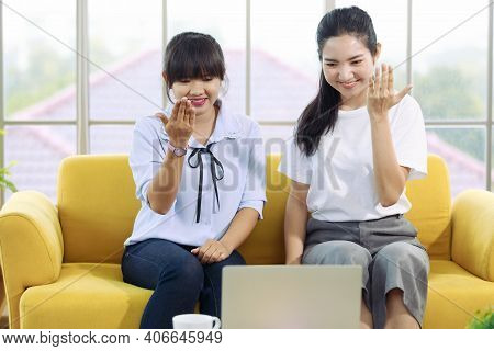 Young And Beautiful Asain Woman Talk To Someone On A Notebook Computer Screen With Hand Sign, Deaf L