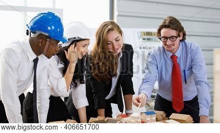 A Man African American Engineering And Caucasian Standing Holds Coffee. In Group Meetings Viewing A 