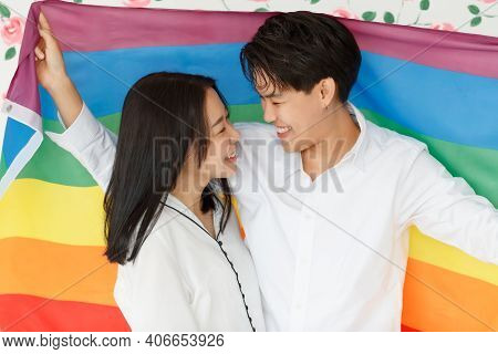 Lgbtq Couple Lovers, A Handsome Girl As A Man Or Butch Femme Covered 
With The Rainbow Flag The Symb