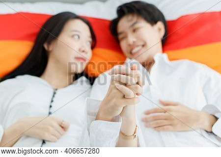 Lgbtq Couple Lovers, A Handsome Girl As A Man Or Butch Femme Laying And Hold Hands On Lgbt Symbol Fl