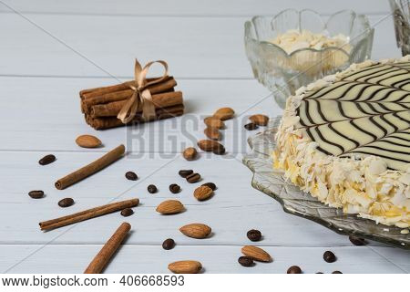 Delicious Esterhazy Cake, Cinnamon, Almonds, Coffee And Walnuts, On A Light Wooden Table, Copy Space