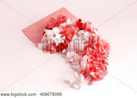Red Envelope Full Of Flowers  Over A Pink Background Close Up