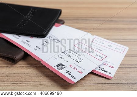 Avia Tickets And Passports On Wooden Table, Closeup. Travel Agency Concept
