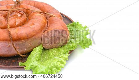 Smoked Sausage Twisted In A Spiral And Bound With A Beechnut, Isolated On A White Background.