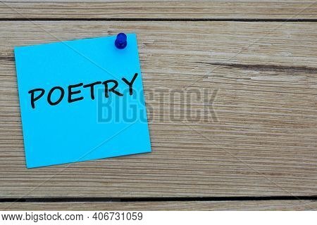 Poetry Is An Word Written On A Blue Sheet Attached To A Wooden Board. Busines Concept. Keep It Simpl