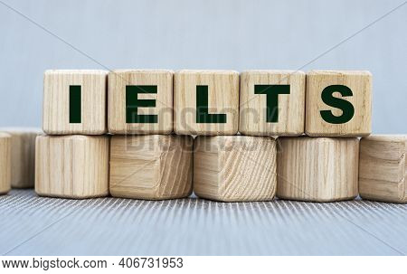 Ielts - Word On Wooden Cubes On A Beautiful Gray Background. Beliefs Psychology Concept.
