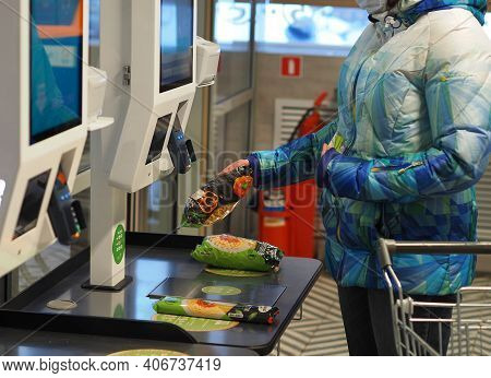The Latest Technologies. Self-service Checkout In The Supermarket. A Woman Buys Groceries In A Super