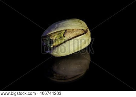 Roasted Pistachio Resting On A Black Reflective Background.