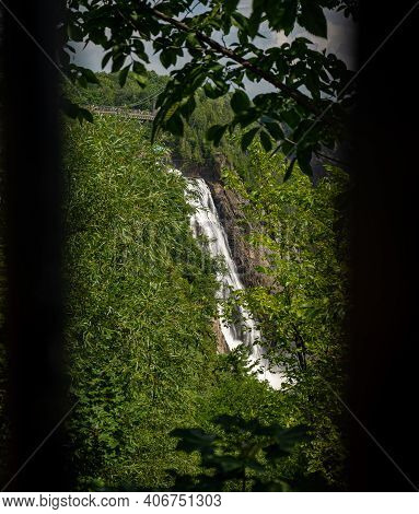Cloudy Summer Day With Insane View Of Beautiful And Powerful Montmorency Waterfall From The Bush