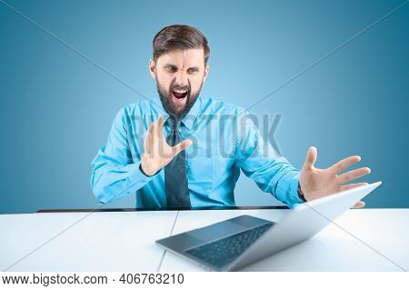 A Bearded Businessman Behind A Laptop Holds Out His Hands And Shouts, A Man In A Blue Shirt Shows Th