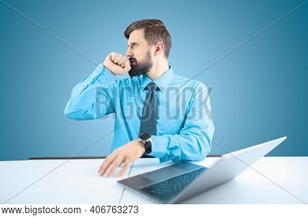 A Bearded Businessman At A Computer Presses His Fist To His Lips And Makes A Gesture Of Regret, A Ma