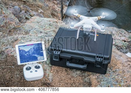 Big Narrows, Poudre Canyon, CO, USA - March 27, 2016:  DJI Phantom 3 quadcopter drone is  ready to take off in a mountain river canyon