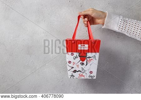 Gift Wrapping Of Rafaello Sweets In A Female Hand On A Light Background. 02.05.2021. Kremenchug. Ukr