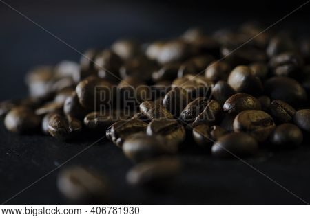 Grains Of Black Aromatic Coffee. Coffee Beans On A Dark Background. The Concept Of A Classic Texture